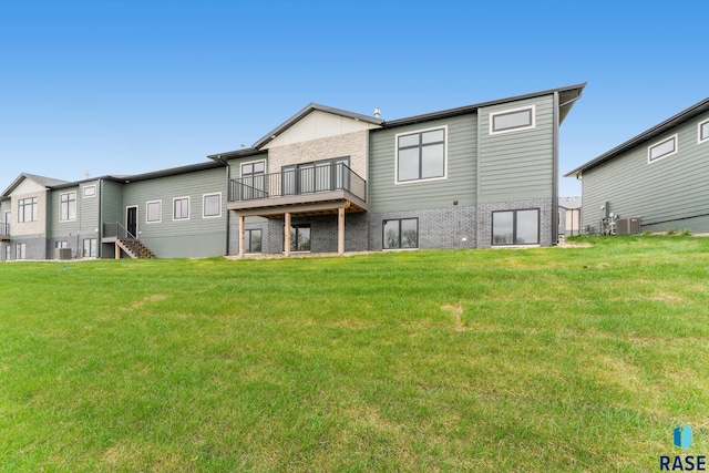 rear view of house featuring a yard and central AC unit