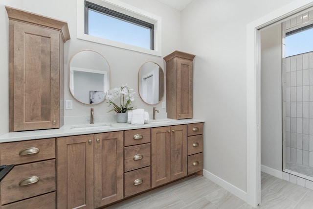 bathroom with vanity, plenty of natural light, and a tile shower