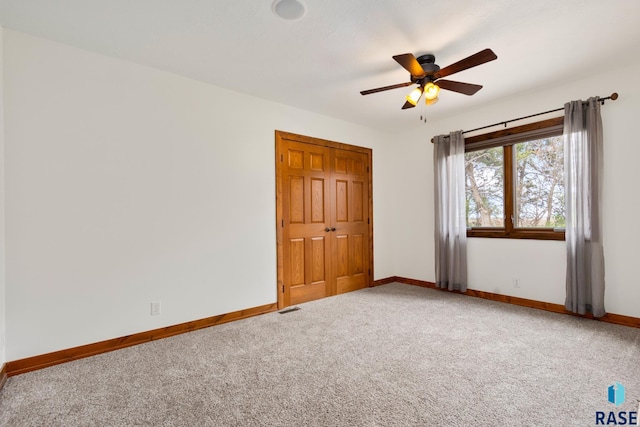 carpeted empty room with ceiling fan