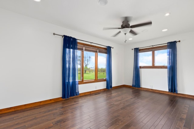 unfurnished room with ceiling fan and dark hardwood / wood-style flooring