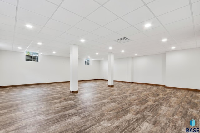 basement featuring hardwood / wood-style floors and a drop ceiling