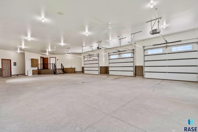 garage with a garage door opener and ceiling fan