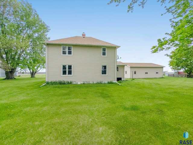 rear view of house with a yard