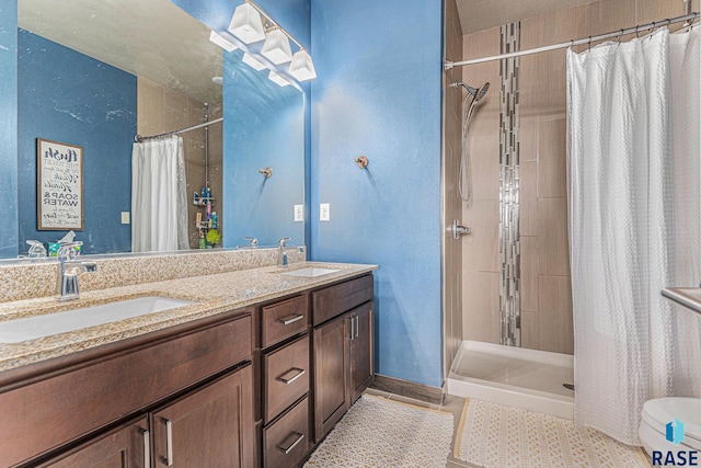 bathroom with walk in shower, tile patterned flooring, and double sink vanity