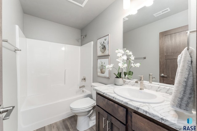 full bathroom featuring vanity, wood-type flooring, bathtub / shower combination, and toilet