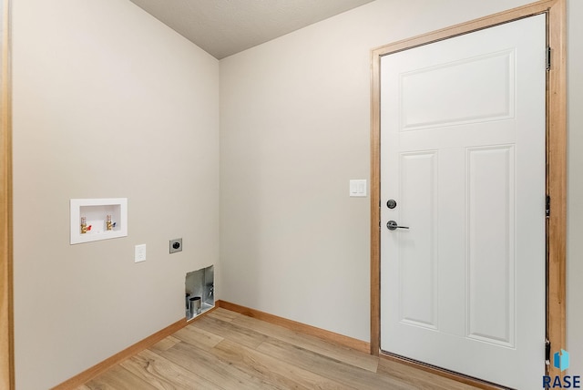 laundry area featuring electric dryer hookup, light hardwood / wood-style floors, and hookup for a washing machine