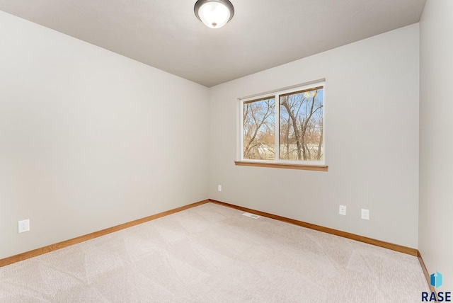 unfurnished room featuring light carpet