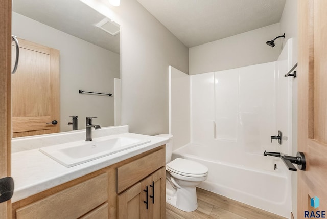 full bathroom with washtub / shower combination, wood-type flooring, toilet, and vanity