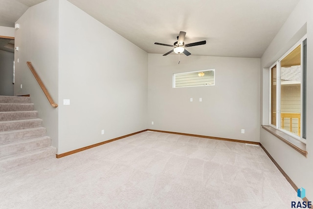 unfurnished room with ceiling fan, light colored carpet, and vaulted ceiling