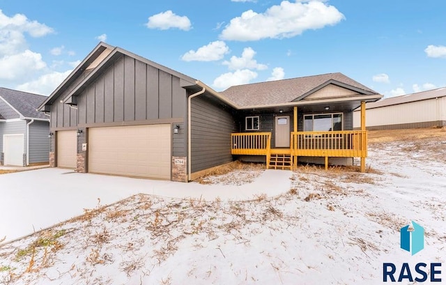 view of front of house featuring a porch and a garage