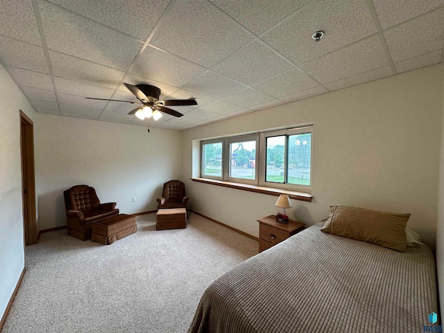 unfurnished bedroom with carpet flooring, a paneled ceiling, and ceiling fan