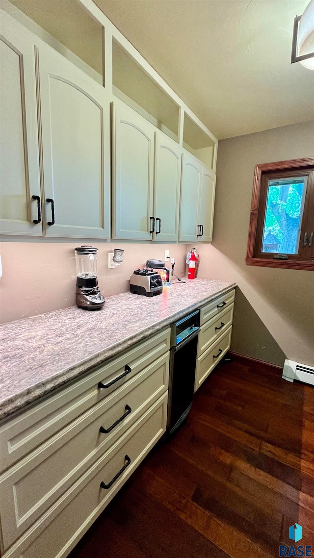 kitchen featuring dishwasher and dark hardwood / wood-style flooring