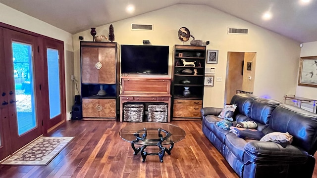 living room with a wealth of natural light, dark hardwood / wood-style floors, and lofted ceiling