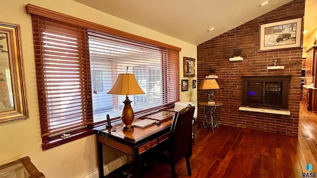 office area with dark hardwood / wood-style flooring, a fireplace, lofted ceiling, and brick wall