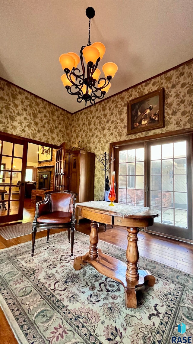 recreation room with a textured ceiling, a notable chandelier, and hardwood / wood-style floors