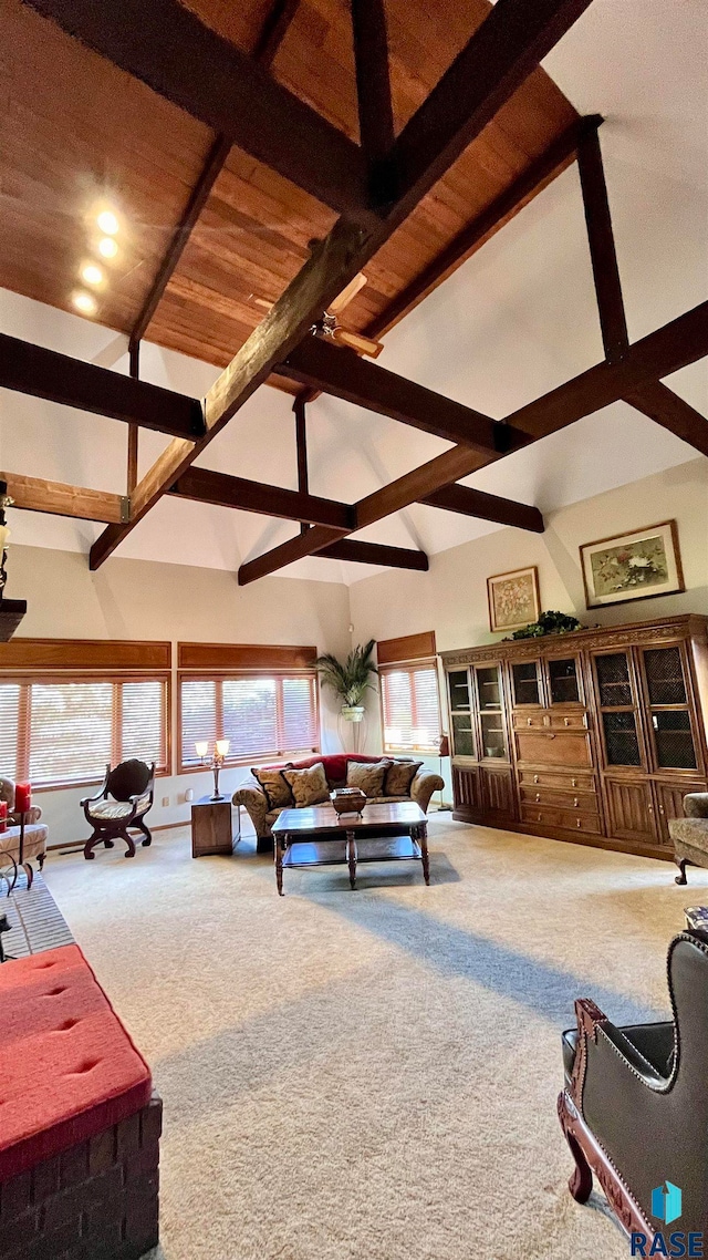 living room featuring carpet flooring, beamed ceiling, and high vaulted ceiling