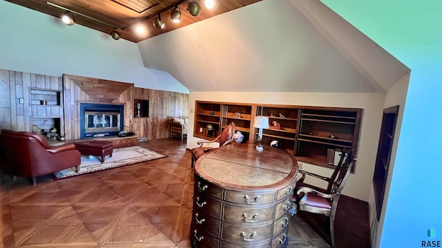 interior space featuring vaulted ceiling and rail lighting