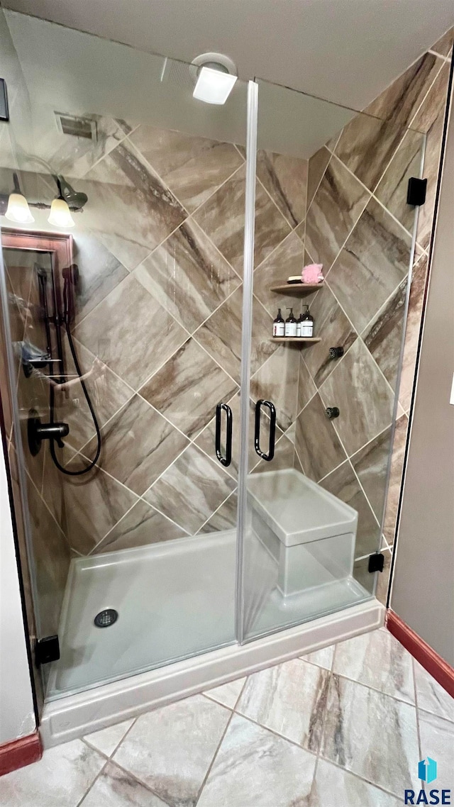 bathroom featuring walk in shower and tile floors