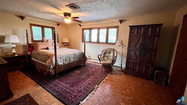 bedroom with ceiling fan, multiple windows, a textured ceiling, and a baseboard radiator