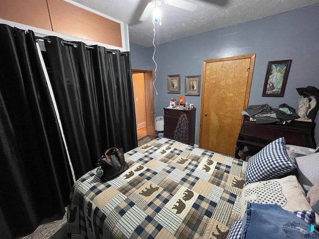 bedroom with ceiling fan and a textured ceiling