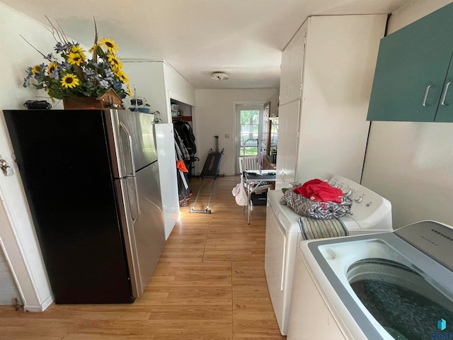 washroom featuring washer and dryer and light hardwood / wood-style floors