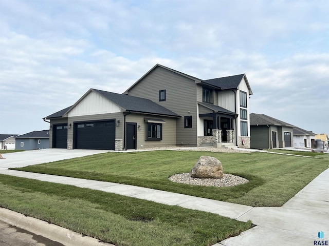 view of front of house featuring a porch, a garage, and a front lawn