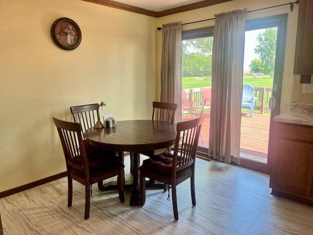 dining space with light hardwood / wood-style flooring and crown molding