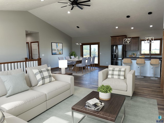 living room with ceiling fan with notable chandelier, a healthy amount of sunlight, lofted ceiling, and wood-type flooring