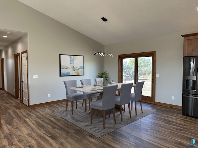 dining area featuring high vaulted ceiling and dark hardwood / wood-style floors