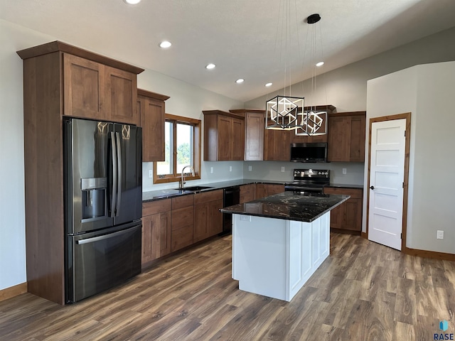 kitchen with pendant lighting, a center island, black appliances, sink, and dark hardwood / wood-style floors