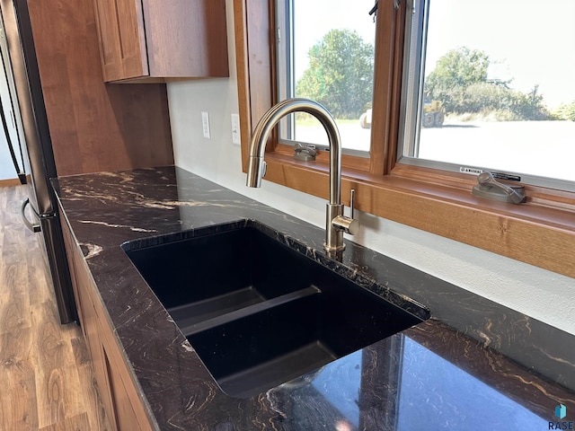 details with dark stone countertops and sink