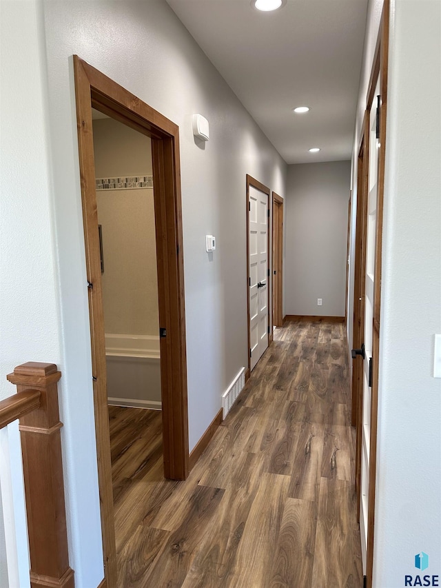 corridor featuring dark wood-type flooring