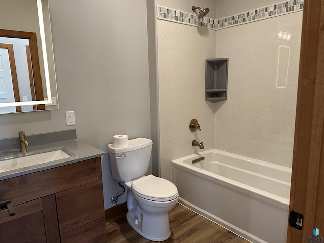 full bathroom with hardwood / wood-style flooring, vanity,  shower combination, and toilet