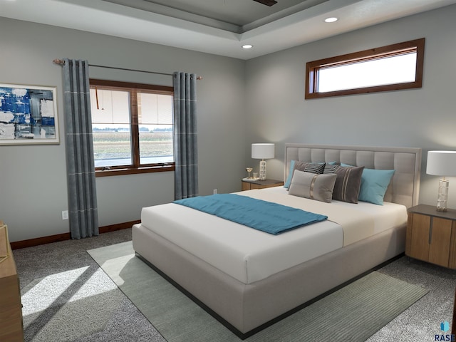 carpeted bedroom featuring a tray ceiling and multiple windows