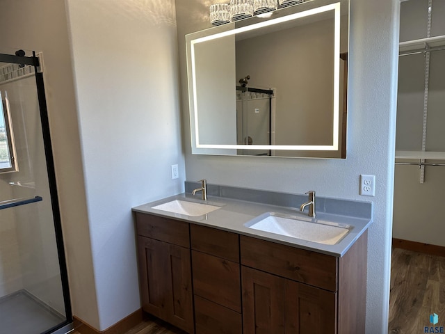 bathroom featuring hardwood / wood-style floors, vanity, and an enclosed shower