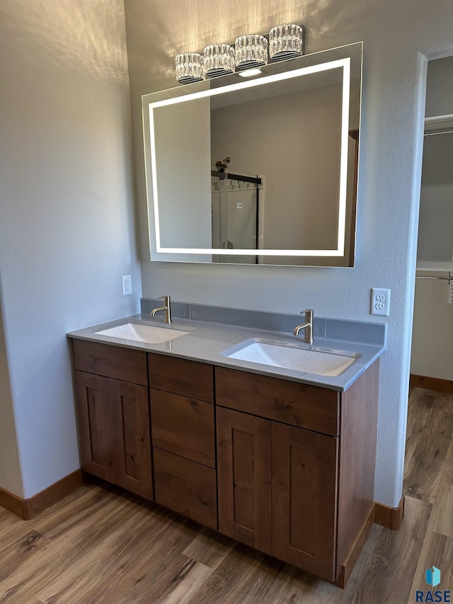 bathroom with hardwood / wood-style floors and vanity