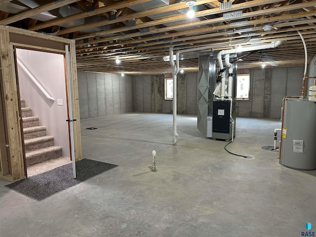 basement featuring heating unit and water heater