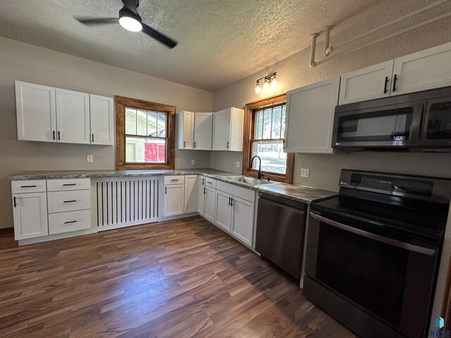 kitchen with a textured ceiling, black appliances, dark wood-type flooring, white cabinetry, and ceiling fan