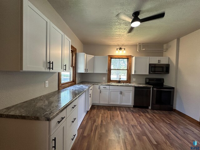 kitchen with a wealth of natural light, ceiling fan, refrigerator, and dark hardwood / wood-style flooring