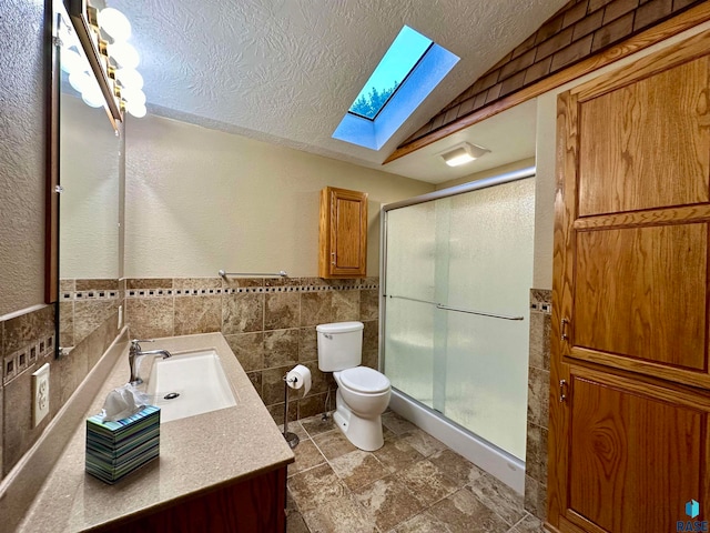 bathroom featuring a textured ceiling, vanity, toilet, and an enclosed shower