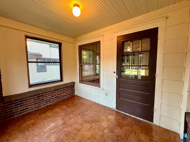 entryway featuring parquet floors and wood ceiling