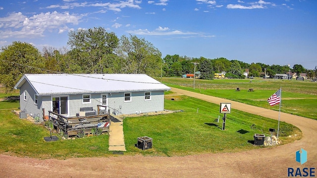 back of house featuring a wooden deck, a yard, and cooling unit