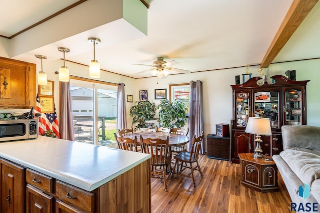 kitchen with ceiling fan, plenty of natural light, pendant lighting, and dark hardwood / wood-style floors