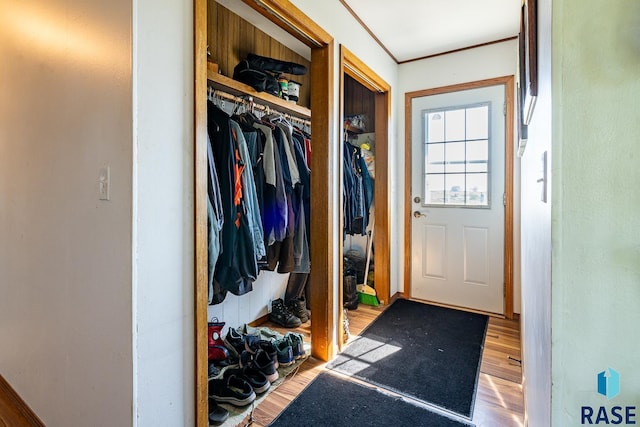 mudroom with hardwood / wood-style floors and crown molding