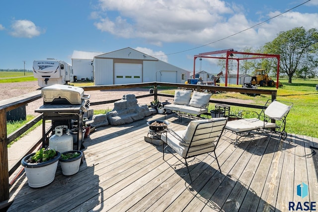 wooden deck featuring outdoor lounge area, a garage, and an outdoor structure