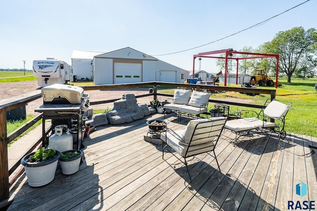 deck with an outbuilding, an outdoor hangout area, and a garage