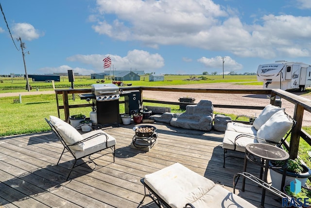 deck with a lawn and grilling area