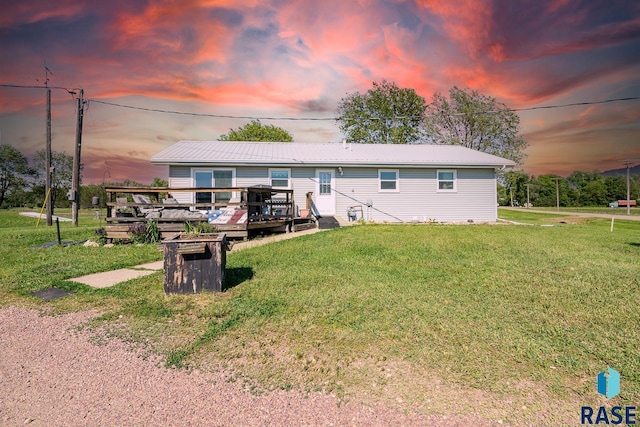 view of front of house with a yard and a wooden deck