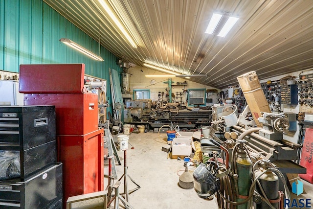 interior space featuring a workshop area, concrete floors, and vaulted ceiling