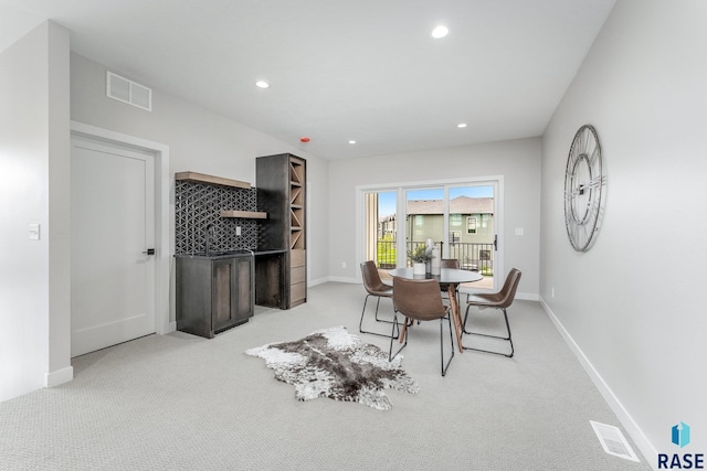 dining space featuring light colored carpet